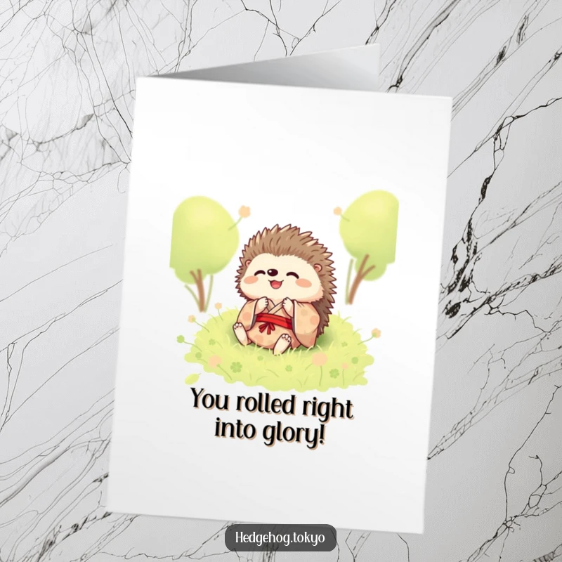Funny free printable congratulations card of a joyful hedgehog in a kimono rolling in moss.